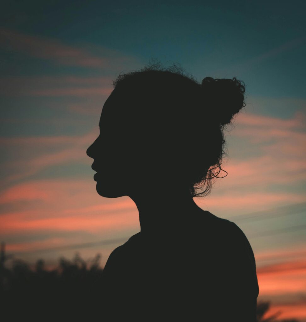 pexels-photo-2475138-2475138 Silhouette of a person against a vibrant sunset sky. Perfect for themes of contemplation and peace.